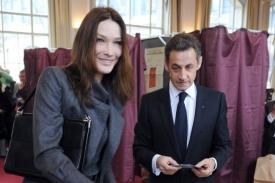 Nicolas Sarkozy se svou manželkou ve volební místnosti.