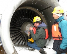 Vědci odebírají vzorky peří z motorů poškozeného letadla.